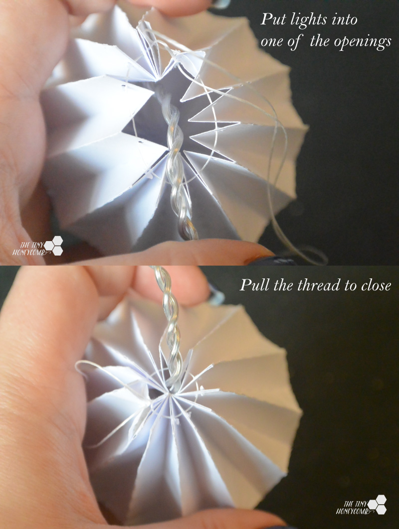 attaching the lights to the origami balls